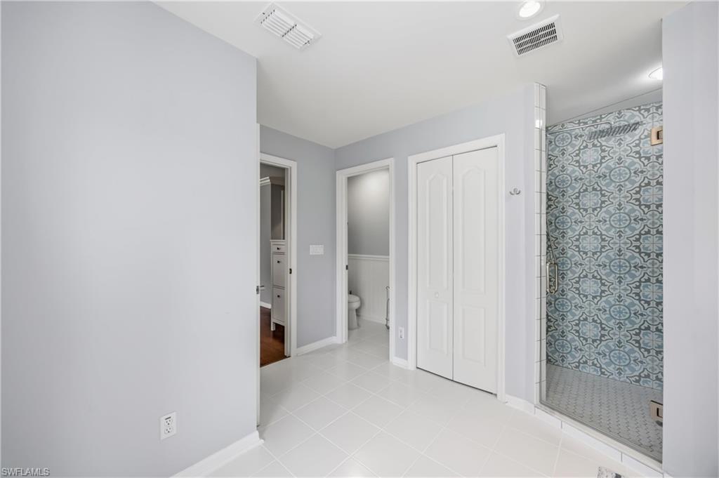 2066 Imperial Circle Naples, FL 34110 - Photo 18 of 29 a view of hallway with closet and a bathroom