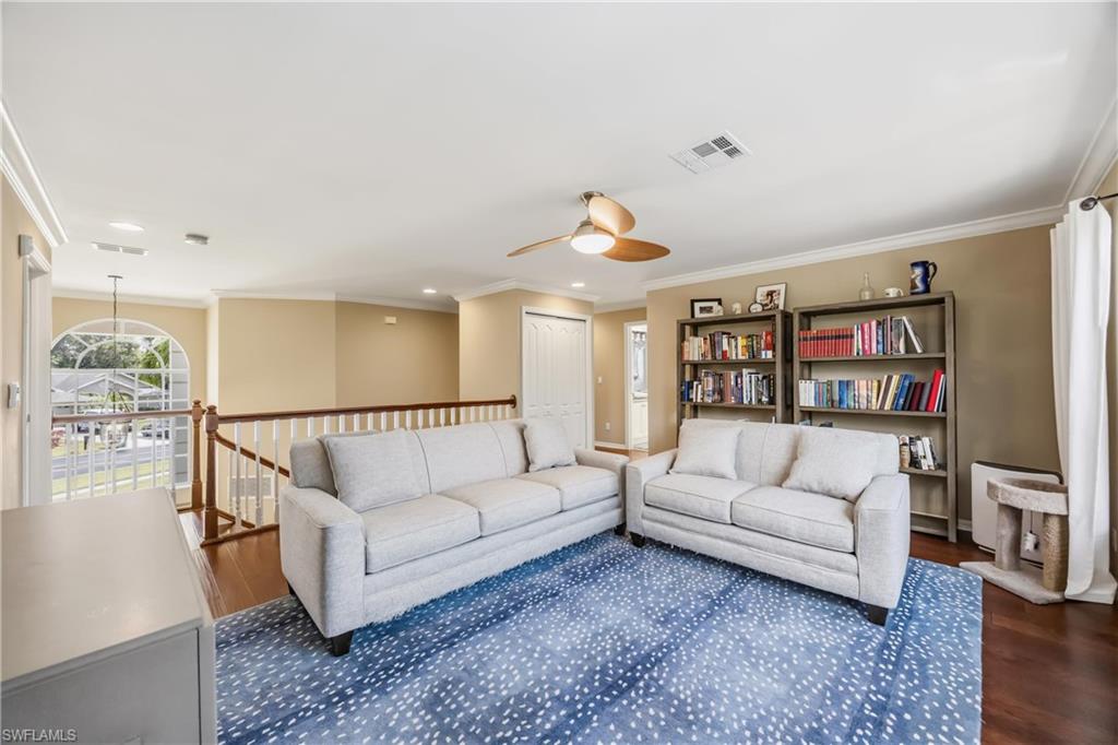 2066 Imperial Circle Naples, FL 34110 - Photo 19 of 29 a living room with furniture and a wooden floor