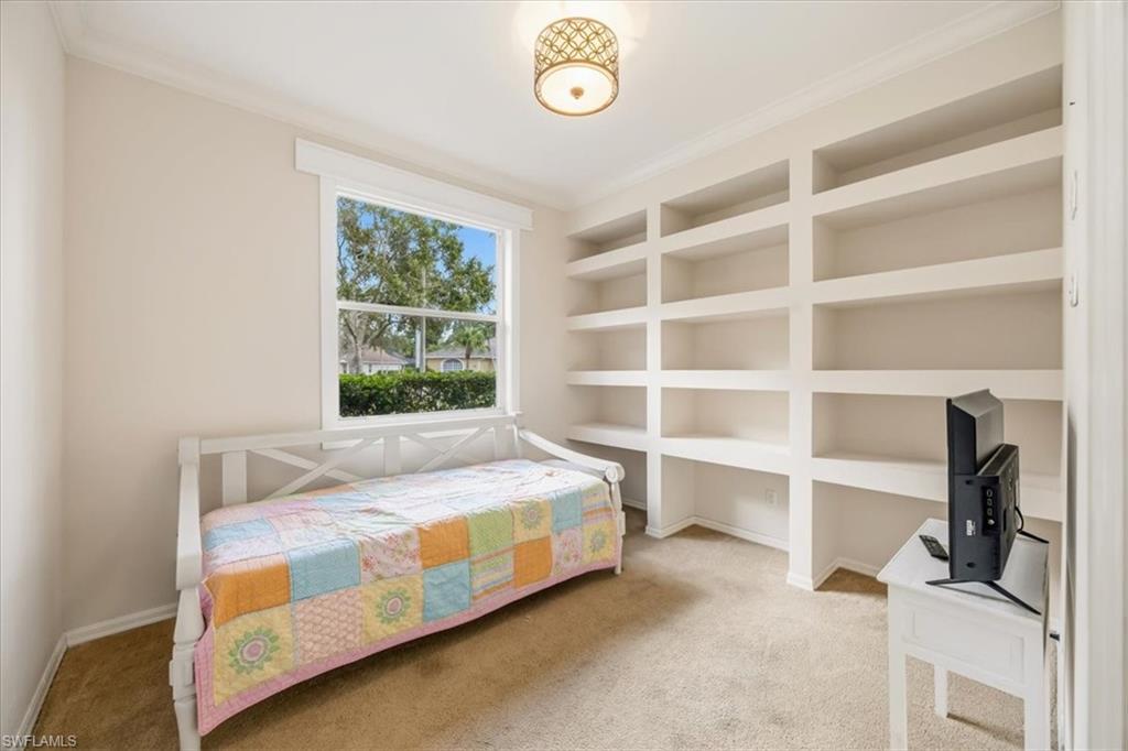 2066 Imperial Circle Naples, FL 34110 - Photo 25 of 29 a bedroom with a bed and a window