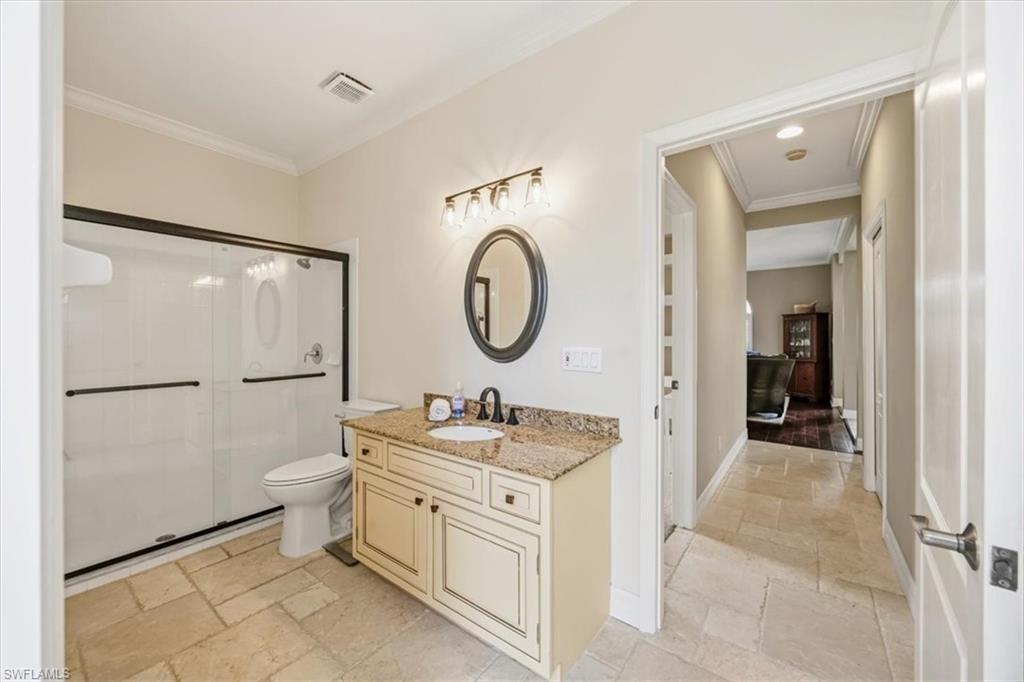 2066 Imperial Circle Naples, FL 34110 - Photo 26 of 29 a bathroom with a toilet sink and a mirror