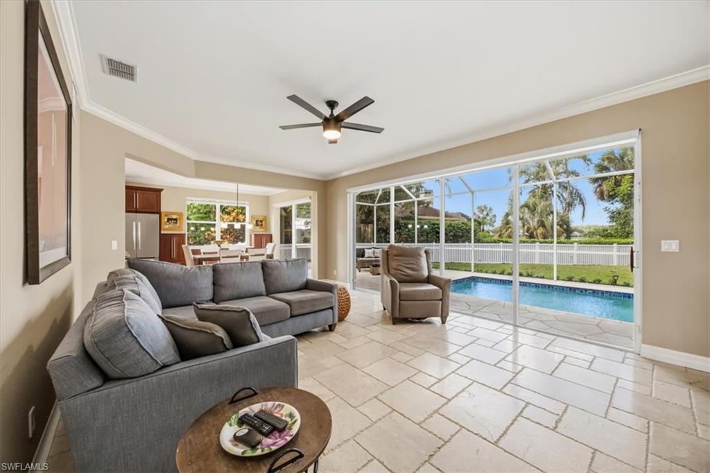 2066 Imperial Circle Naples, FL 34110 - Photo 3 of 29 a living room with furniture and a large window