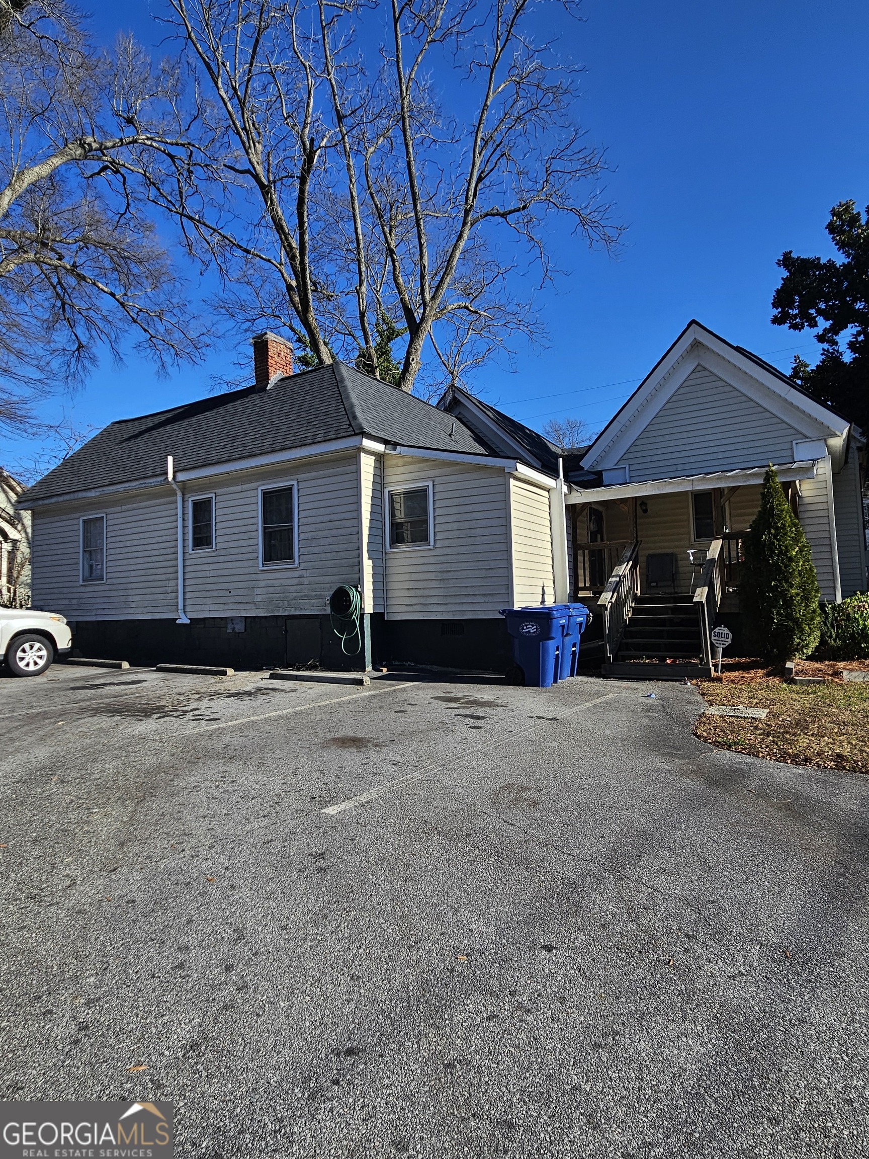 160 North Broad Street Winder, GA 30680 - Photo 7 of 10 a front view of a house with basket ball court and a garage
