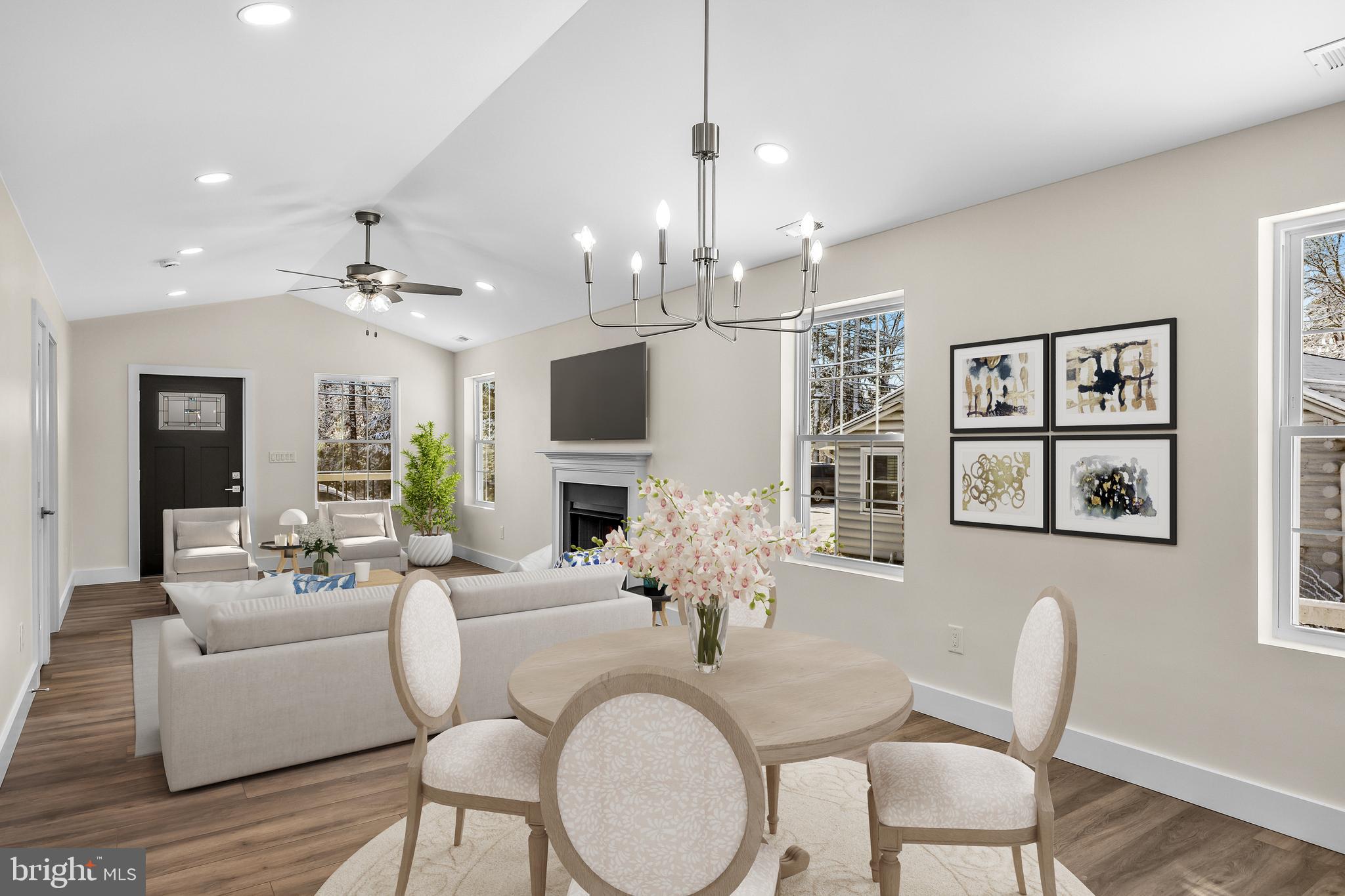 154 Taunton Boulevard Medford, NJ 08055 - Photo 7 of 33 a living room with furniture a chandelier and a flat screen tv