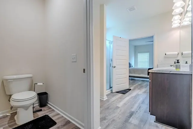 a bathroom with a toilet sink and a mirror