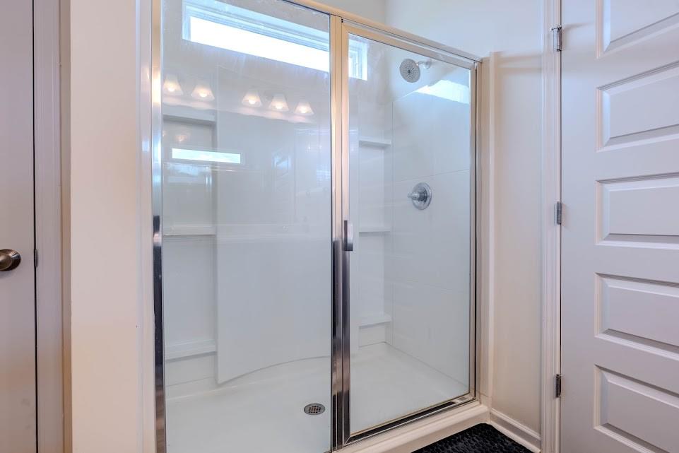 3 Oak Ridge Court Northeast Rome, GA 30165 - Photo 12 of 22 a bathroom with a glass shower door