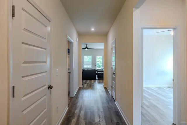 a view of a hallway with wooden floor