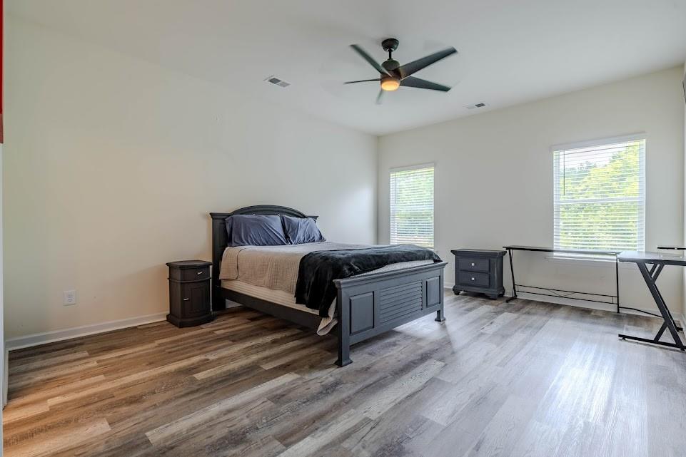 3 Oak Ridge Court Northeast Rome, GA 30165 - Photo 9 of 22 a spacious bedroom with a bed a desk and a window