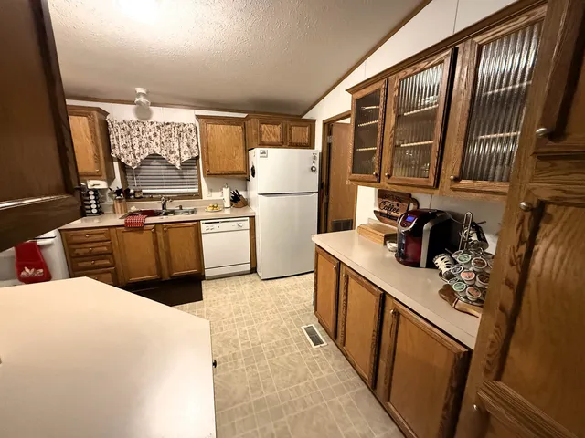 a kitchen with a refrigerator and a sink