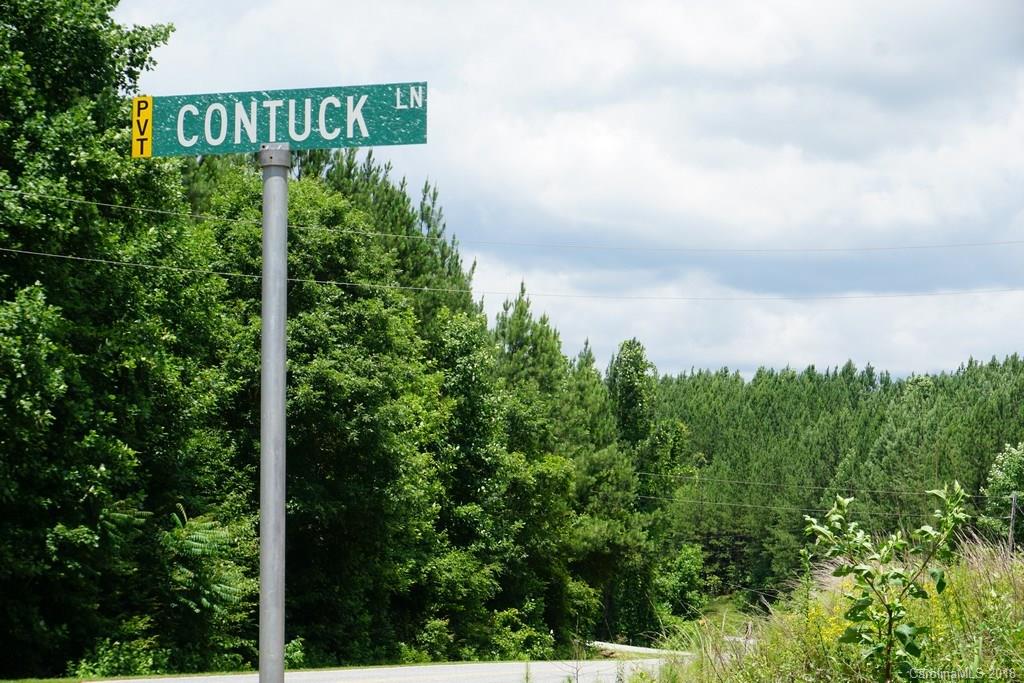 Lot#3 Contuck Ln Mill Spring, Unit 3 Mill Spring, NC 28756 - Photo 14 of 35 a sign that is sitting on a green field