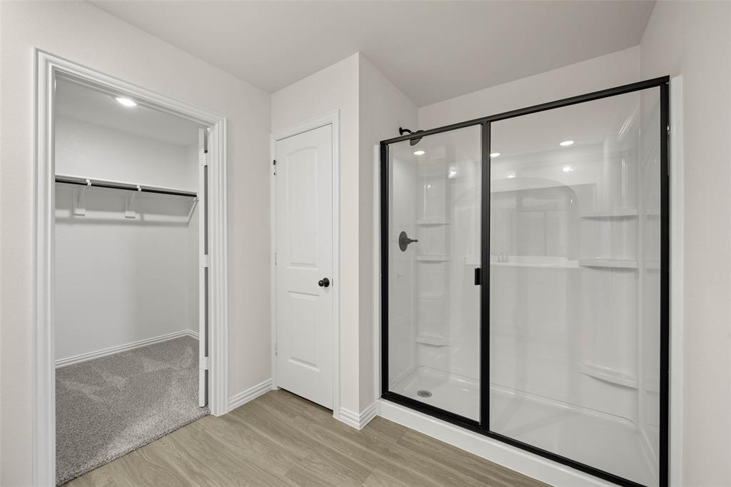 426 Rose Avenue Cleburne, TX 76033 - Photo 19 of 20 a bathroom with a glass shower door