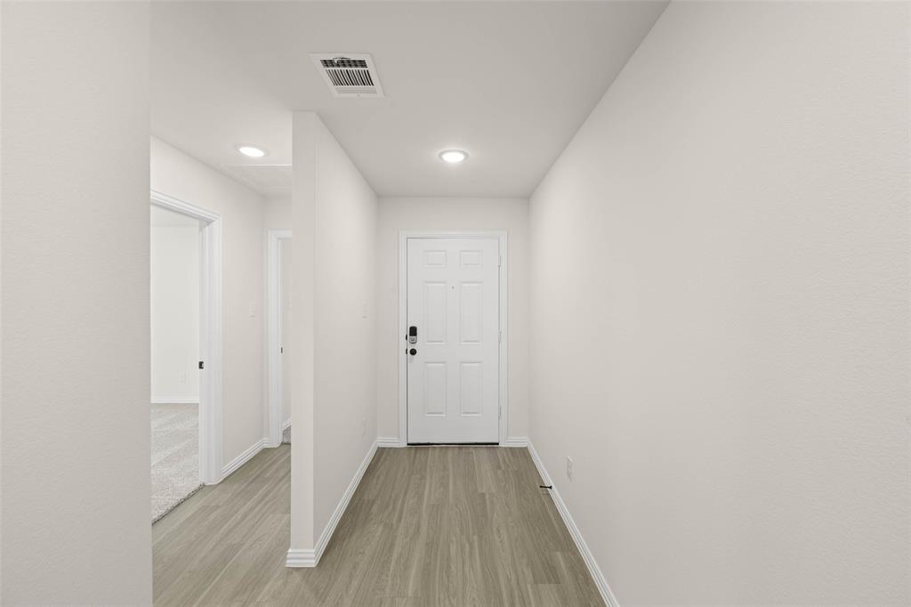 426 Rose Avenue Cleburne, TX 76033 - Photo 2 of 20 a view of a hallway with wooden floor