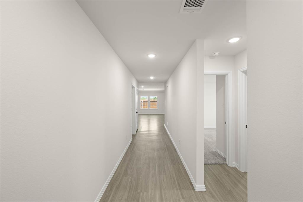 426 Rose Avenue Cleburne, TX 76033 - Photo 3 of 20 a view of a hallway with wooden floor