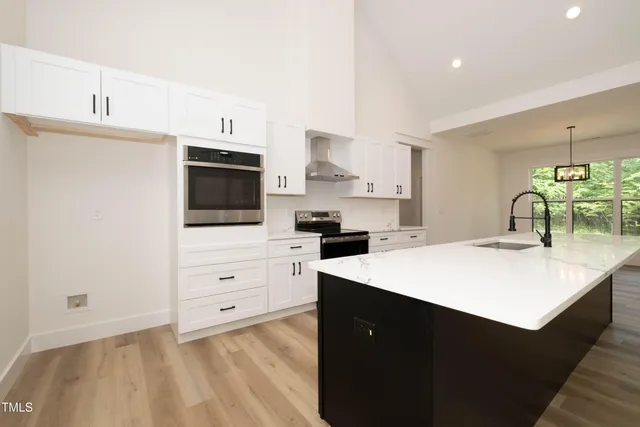 a kitchen with a sink a stove and cabinets
