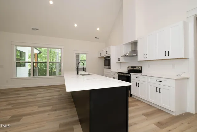 a kitchen with a sink stove and cabinets