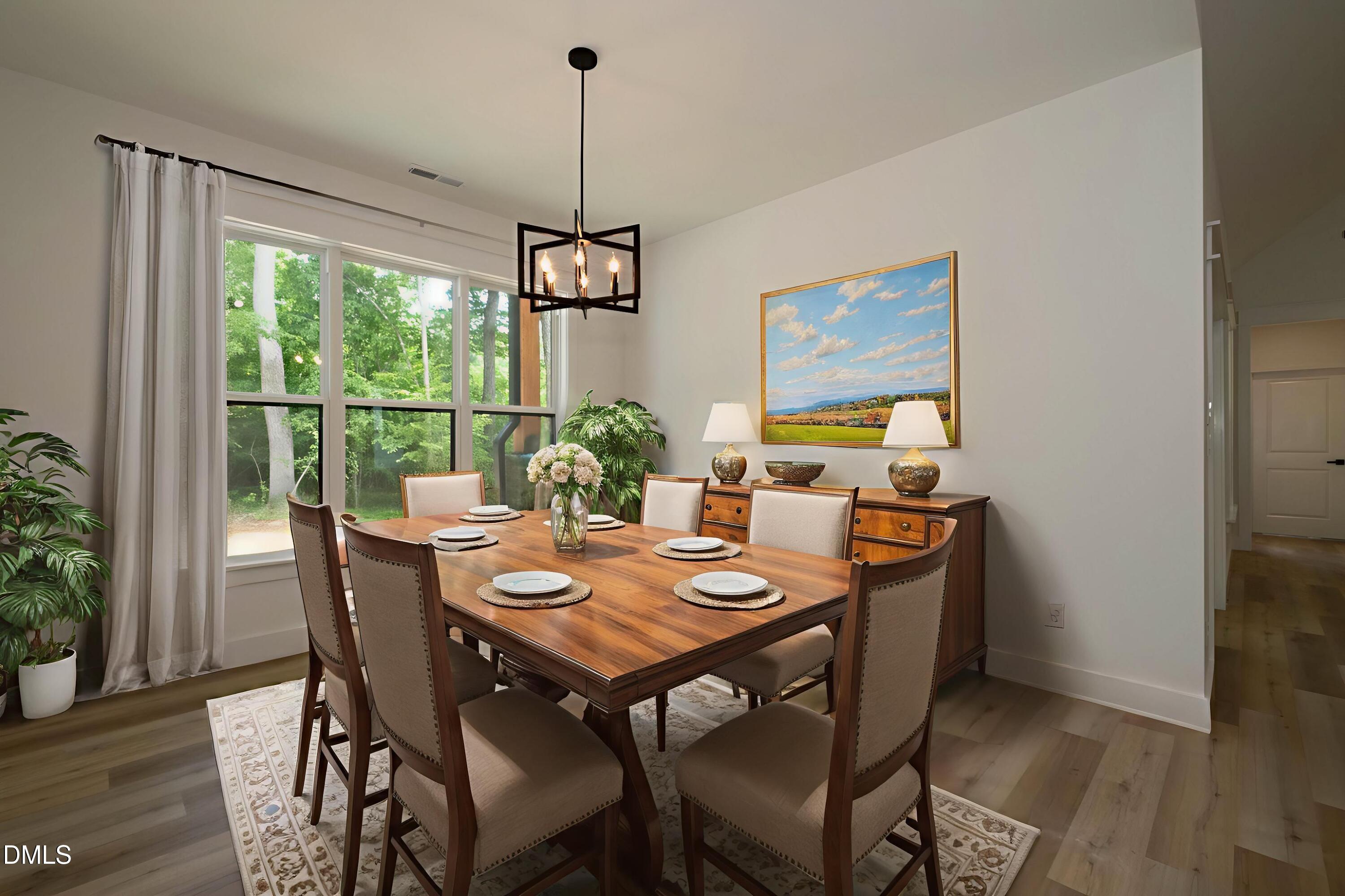 690 Oaks Lane Road Timberlake, NC 27583 - Photo 17 of 31 a view of a dining room with furniture window and wooden floor