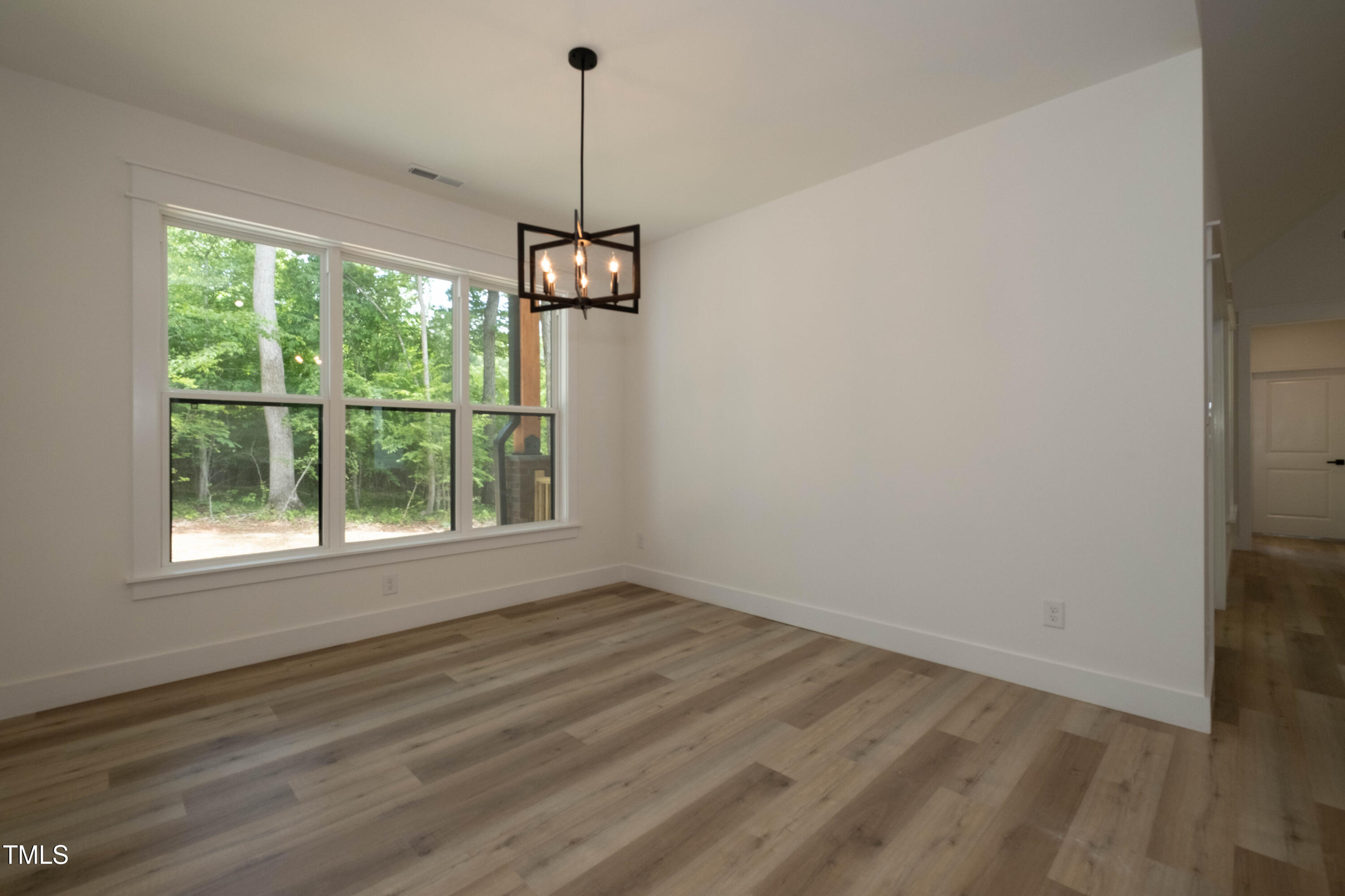 690 Oaks Lane Road Timberlake, NC 27583 - Photo 18 of 31 a view of empty room with window and wooden floor
