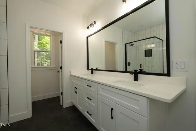 a bathroom with a sink and two mirror