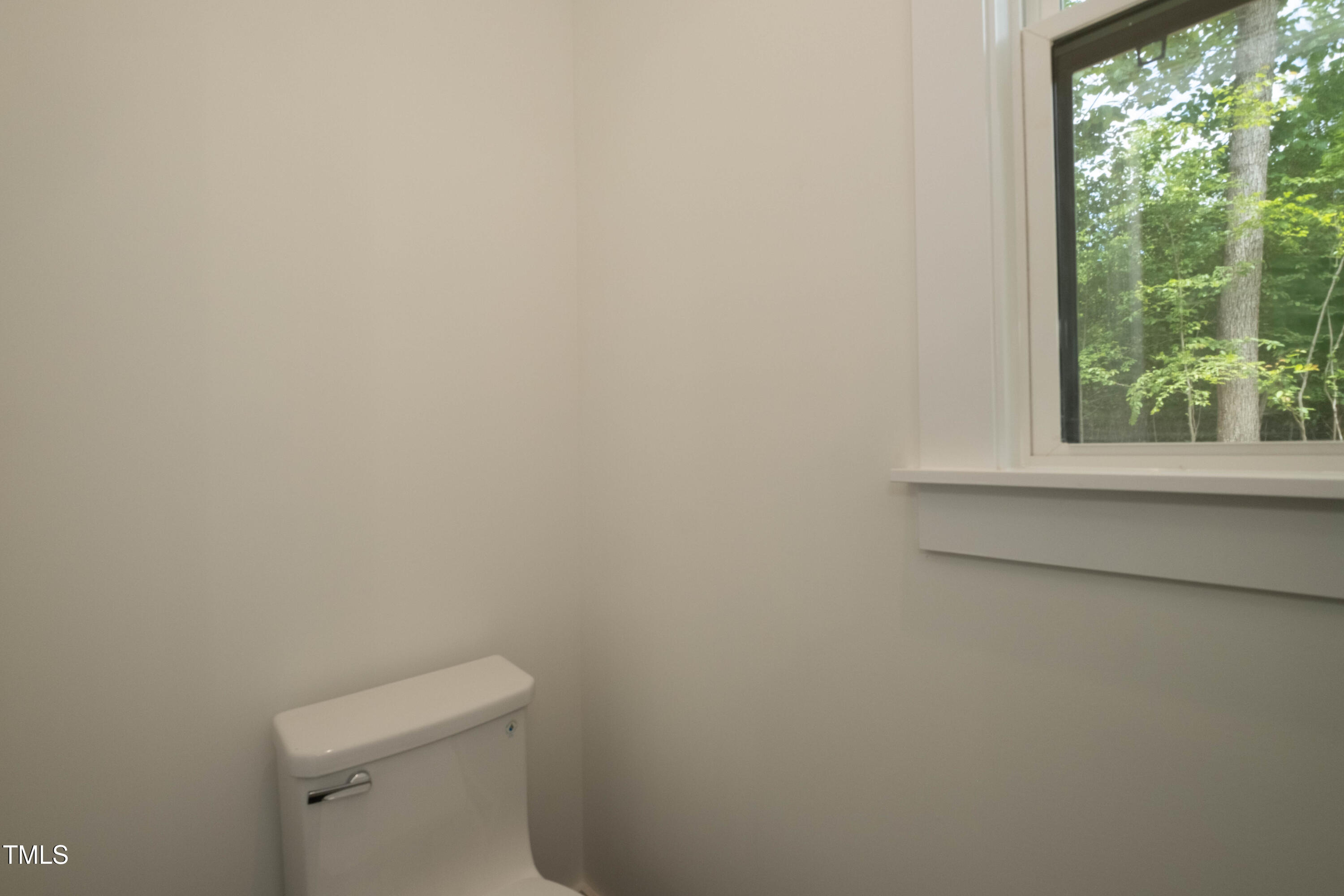 690 Oaks Lane Road Timberlake, NC 27583 - Photo 23 of 31 a white toilet sitting in a bathroom next to a window