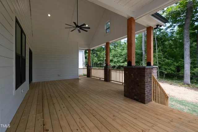 a view of a porch with wooden floor and outdoor space