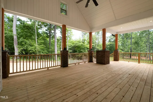 a view of porch with wooden floor and floor to ceiling windows