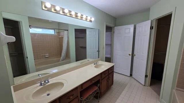 a bathroom with a double vanity sink and a mirror