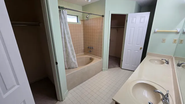 a bathroom with a bathtub and a shower