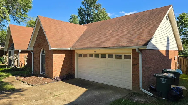 a view of a house with a backyard