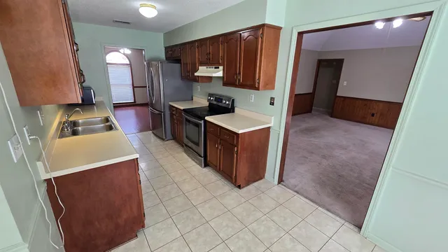 a kitchen with kitchen island cabinets and refrigerator