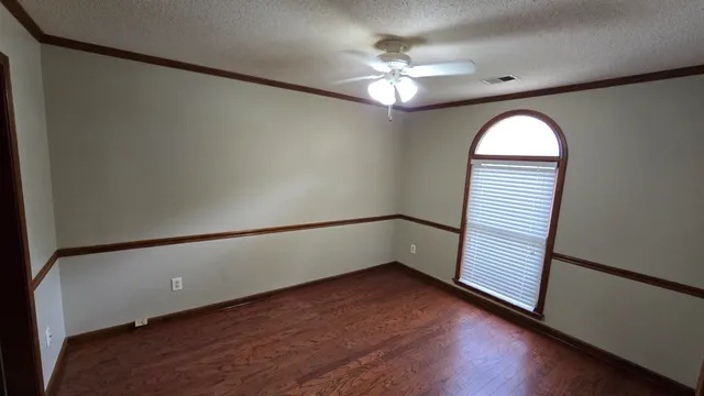 wooden floor in an empty room with a window