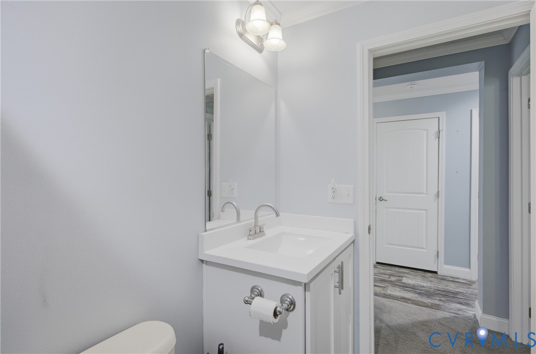 93 Faraway Road Saluda, VA 23149 - Photo 29 of 58 a bathroom with a sink a toilet and vanity
