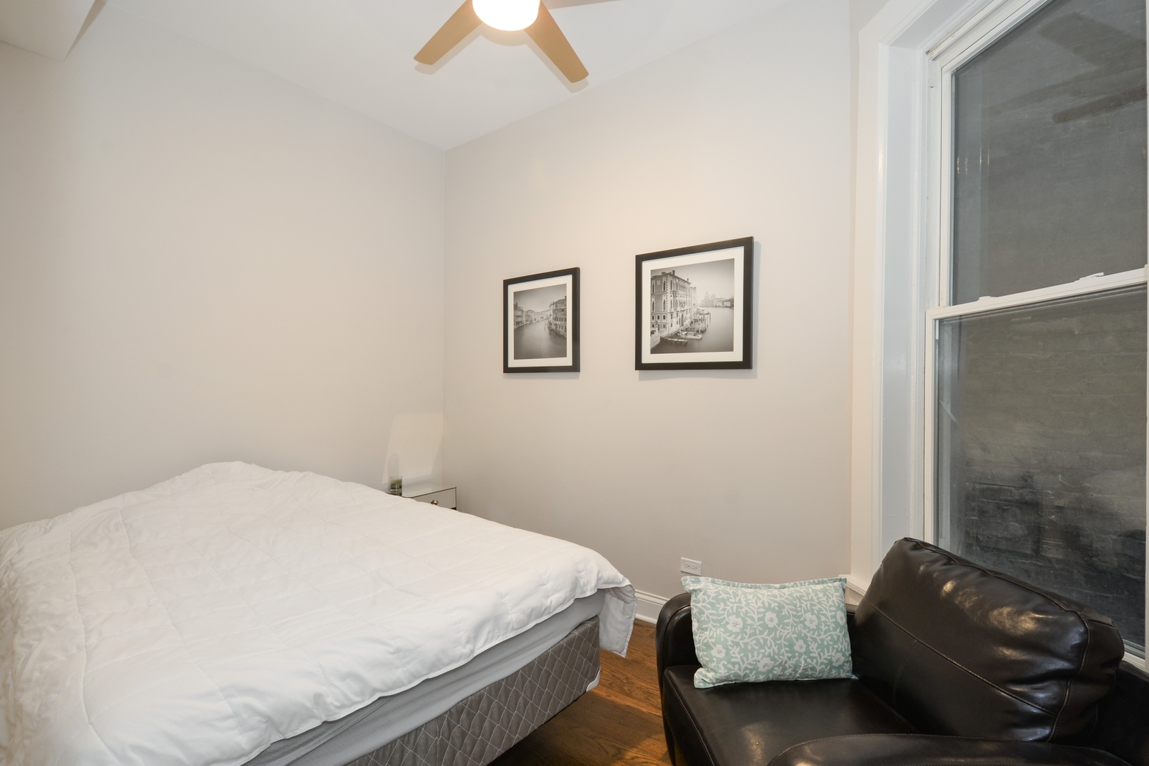 1545 North Claremont Avenue, Unit 2 Chicago, IL 60622 - Photo 9 of 13 a bedroom with a bed and a painting on the wall