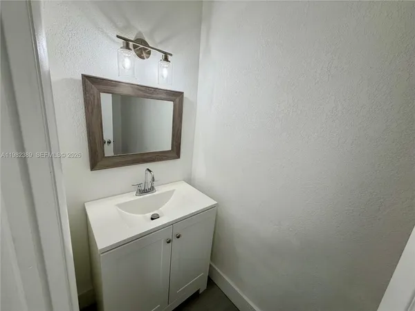a white toilet sitting next to a shower