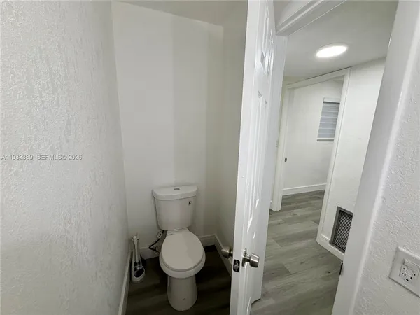 a view of a room with wooden floors and staircase