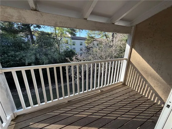 a view of a balcony with wooden floor
