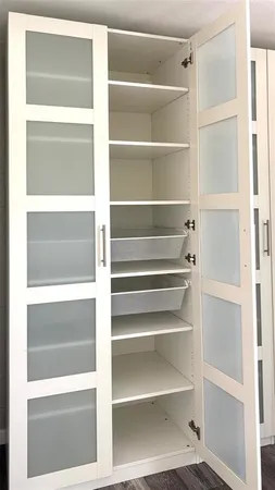 a kitchen with cabinets appliances and wooden floor
