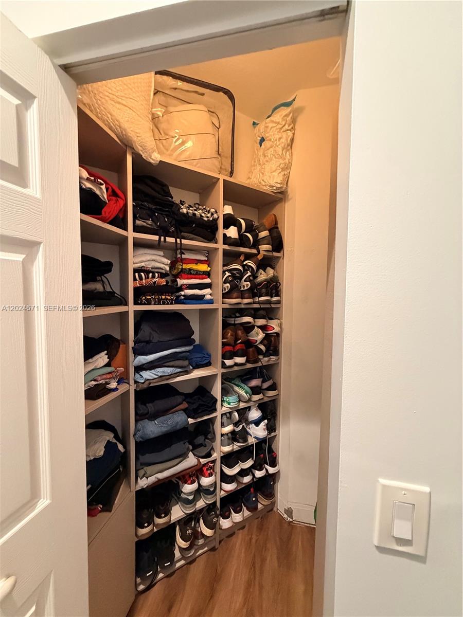 2116 Northeast 38th Road, Unit 2116 Homestead, FL 33033 - Photo 19 of 31 a view of walk in closet with clothes and shoes