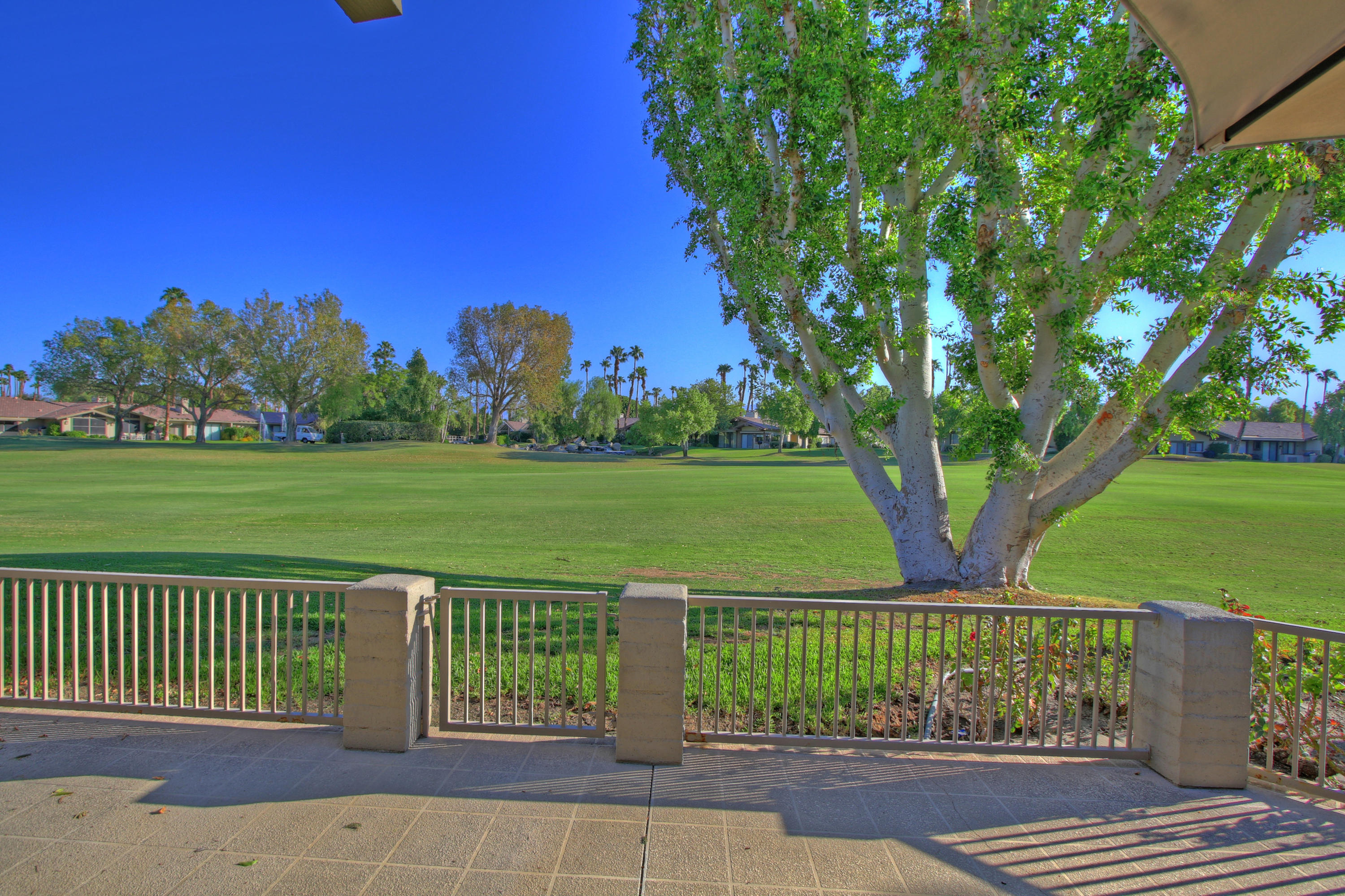 210 Wagon Wheel Road Palm Desert, CA 92211 - Photo 1 of 27 a view of a garden with a lake
