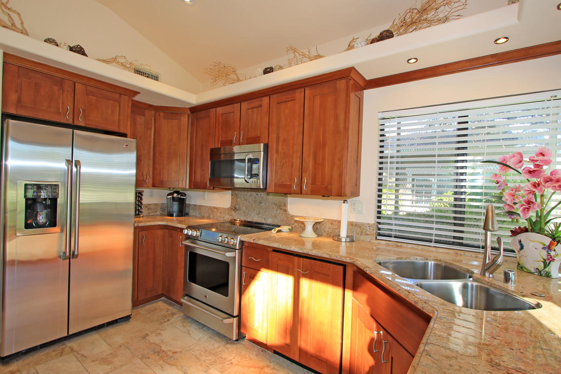 210 Wagon Wheel Road Palm Desert, CA 92211 - Photo 13 of 27 a kitchen with stainless steel appliances granite countertop a sink stove and refrigerator
