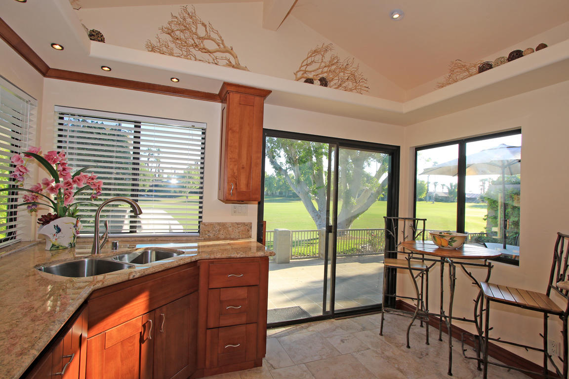 210 Wagon Wheel Road Palm Desert, CA 92211 - Photo 14 of 27 a kitchen with a large window and dining table