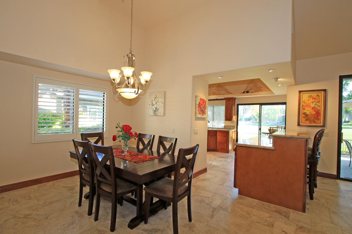 210 Wagon Wheel Road Palm Desert, CA 92211 - Photo 15 of 27 a dining room with furniture a livingroom view and wooden floor