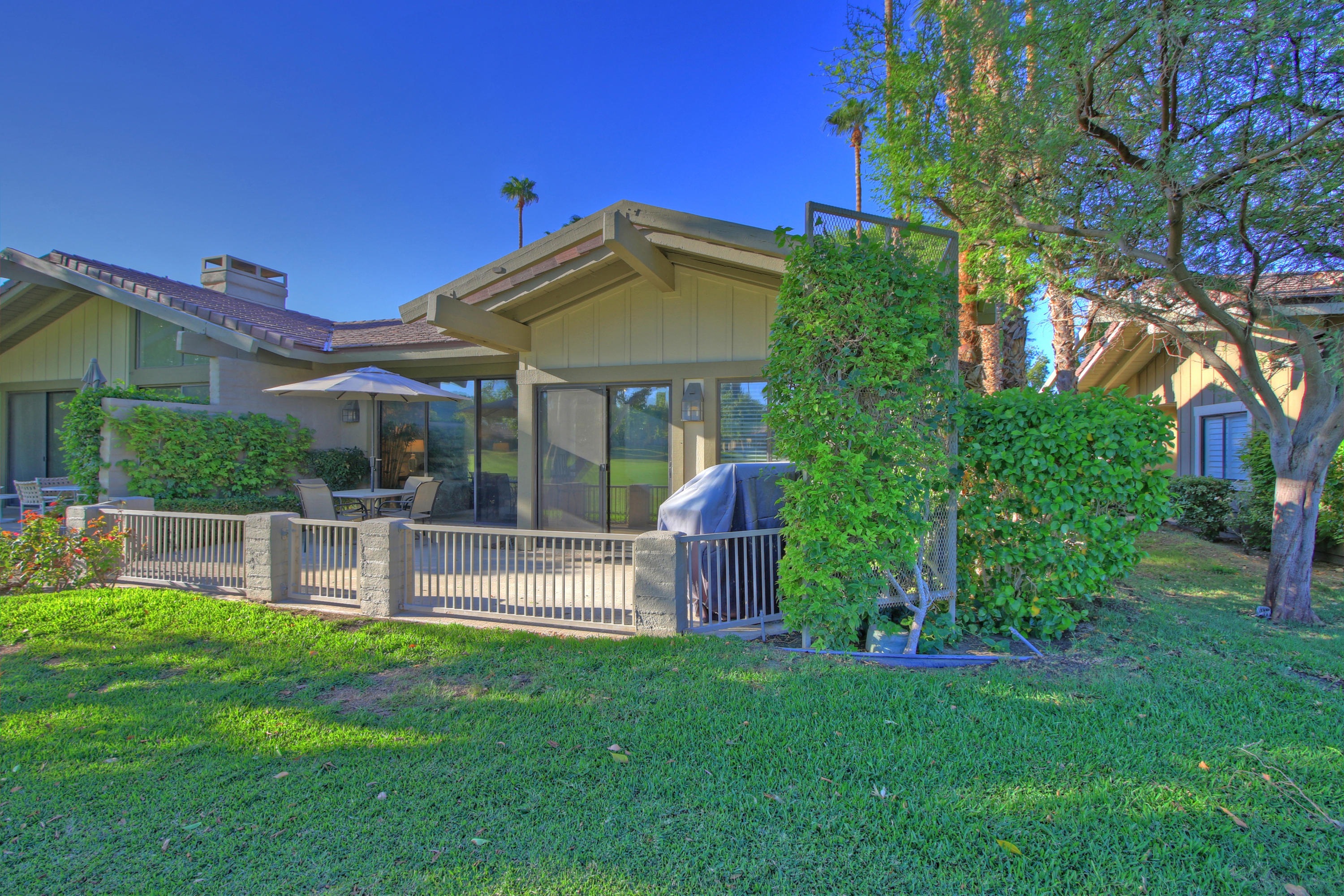 210 Wagon Wheel Road Palm Desert, CA 92211 - Photo 16 of 27 a view of a house with a yard