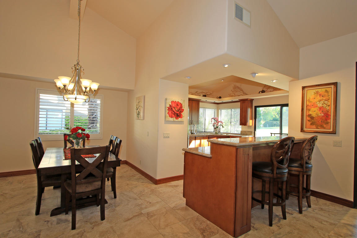 210 Wagon Wheel Road Palm Desert, CA 92211 - Photo 17 of 27 a dining room with furniture window and wooden floor