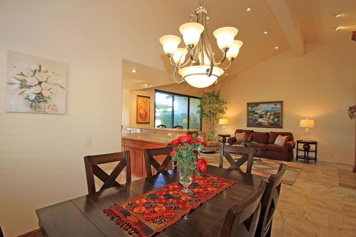 210 Wagon Wheel Road Palm Desert, CA 92211 - Photo 18 of 27 a living room with fireplace furniture and a chandelier