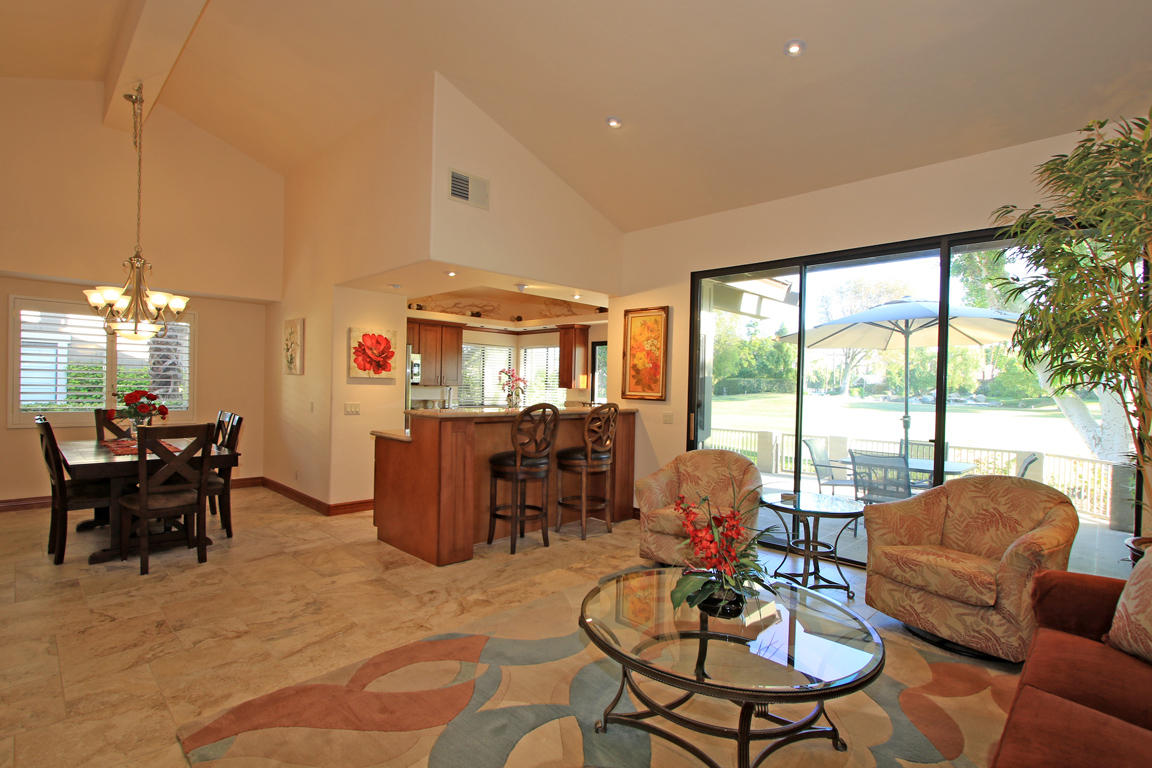 210 Wagon Wheel Road Palm Desert, CA 92211 - Photo 2 of 27 a living room with furniture and a large window