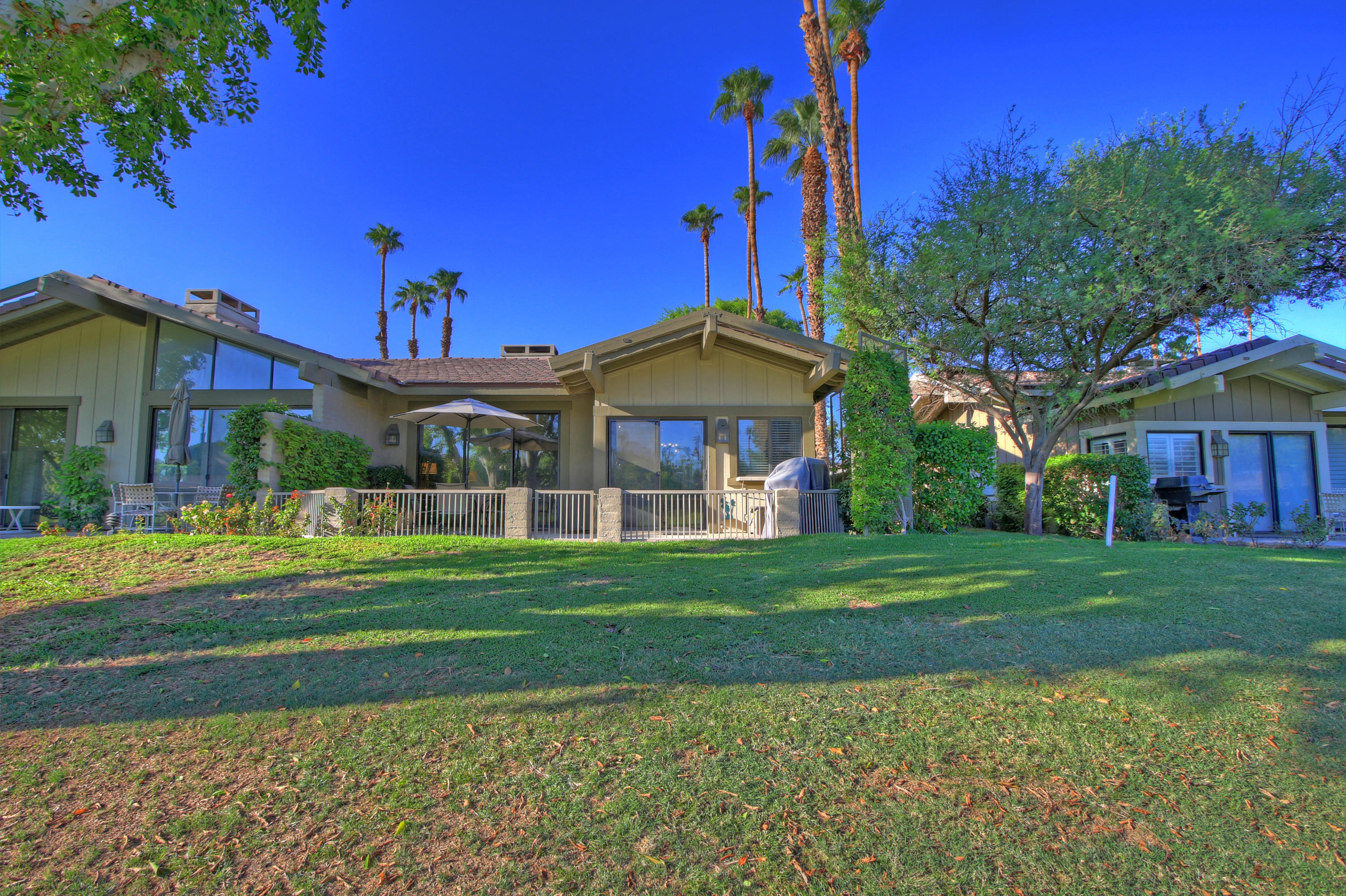 210 Wagon Wheel Road Palm Desert, CA 92211 - Photo 25 of 27 a front view of a house with a yard