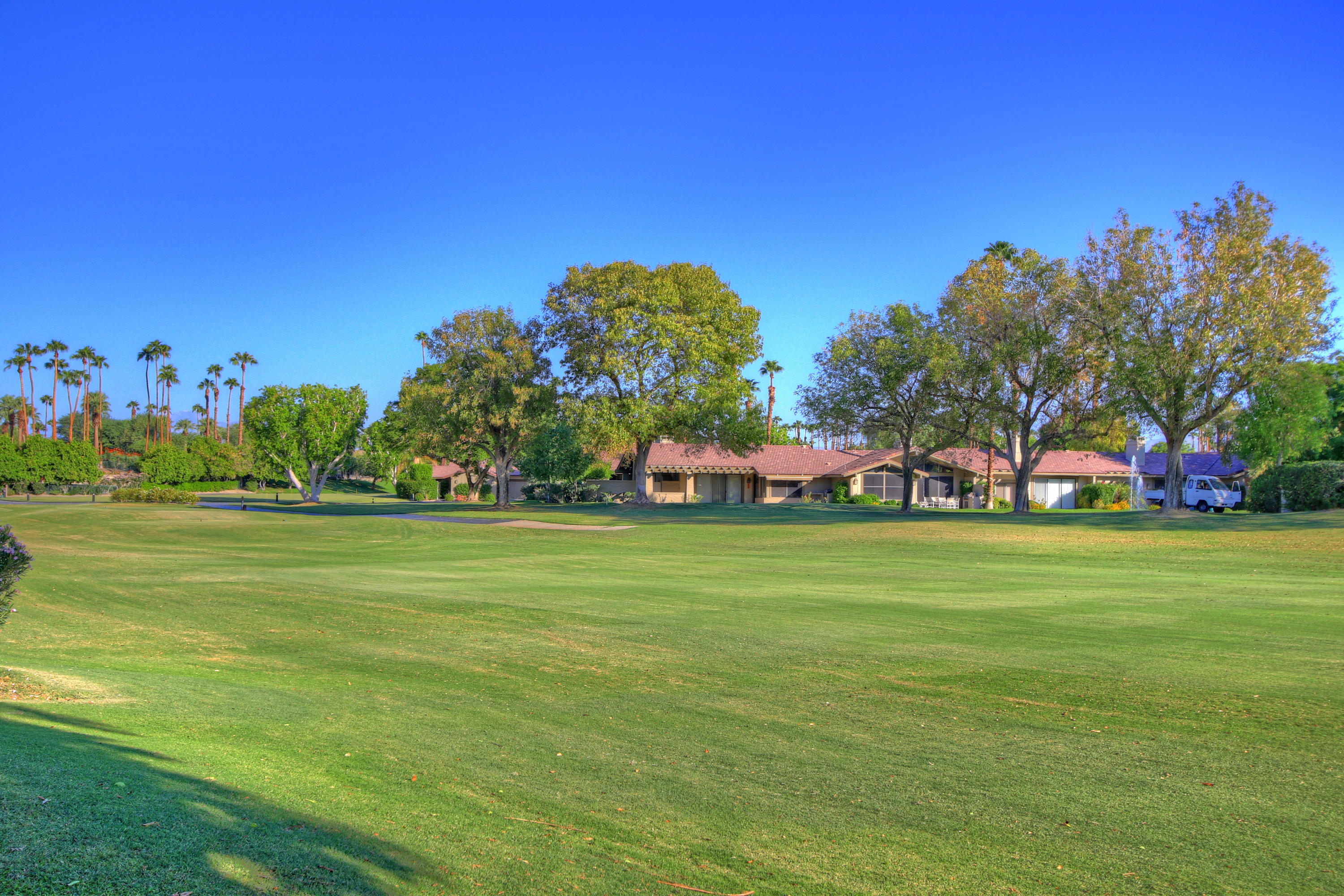 210 Wagon Wheel Road Palm Desert, CA 92211 - Photo 3 of 27 a front view of a house with a big yard