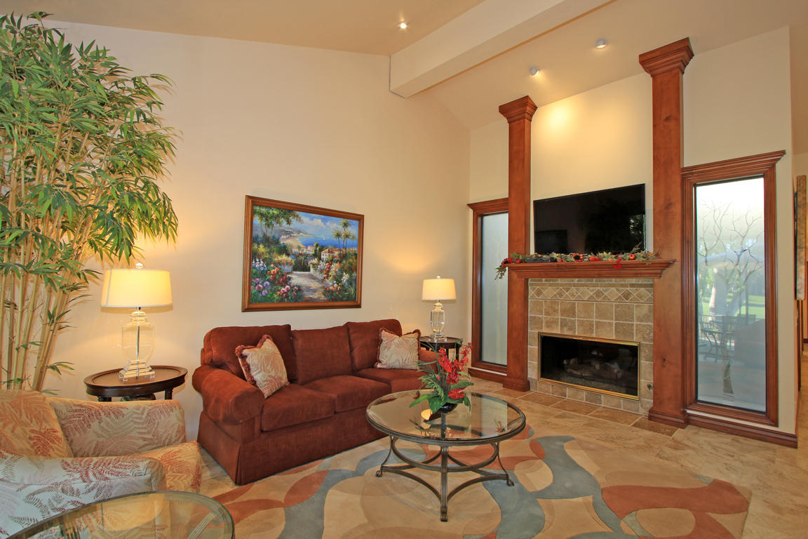 210 Wagon Wheel Road Palm Desert, CA 92211 - Photo 4 of 27 a living room with furniture a fireplace and a flat screen tv