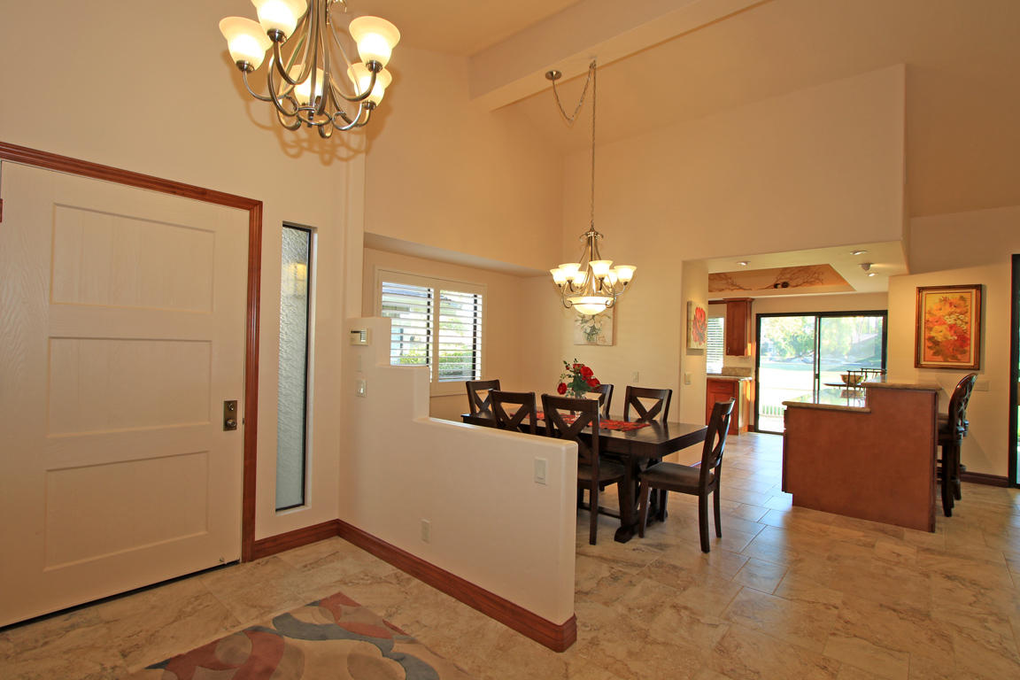 210 Wagon Wheel Road Palm Desert, CA 92211 - Photo 6 of 27 a view of a dining room with furniture window and chandelier