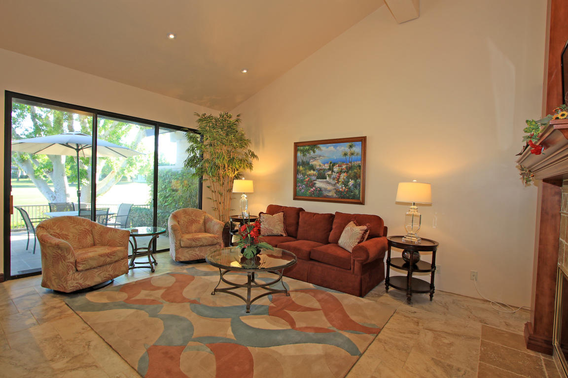 210 Wagon Wheel Road Palm Desert, CA 92211 - Photo 7 of 27 a living room with furniture and a large window