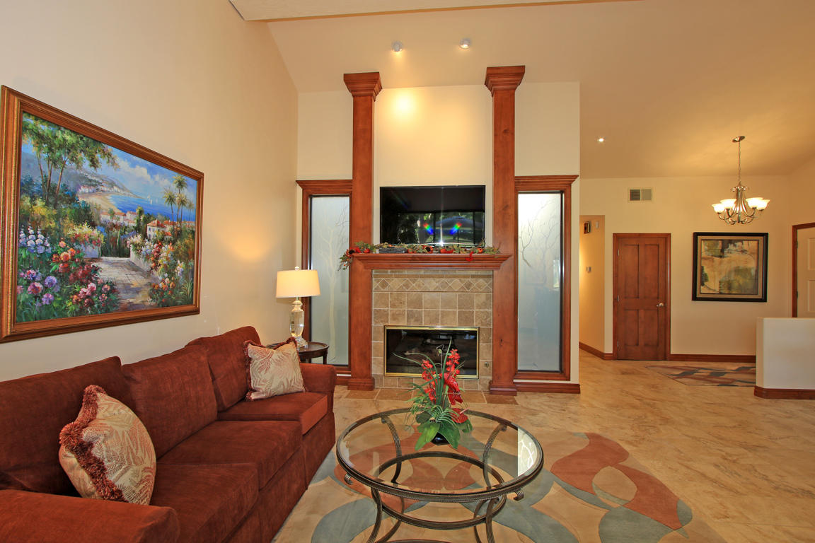 210 Wagon Wheel Road Palm Desert, CA 92211 - Photo 8 of 27 a living room with furniture a fireplace and a flat screen tv